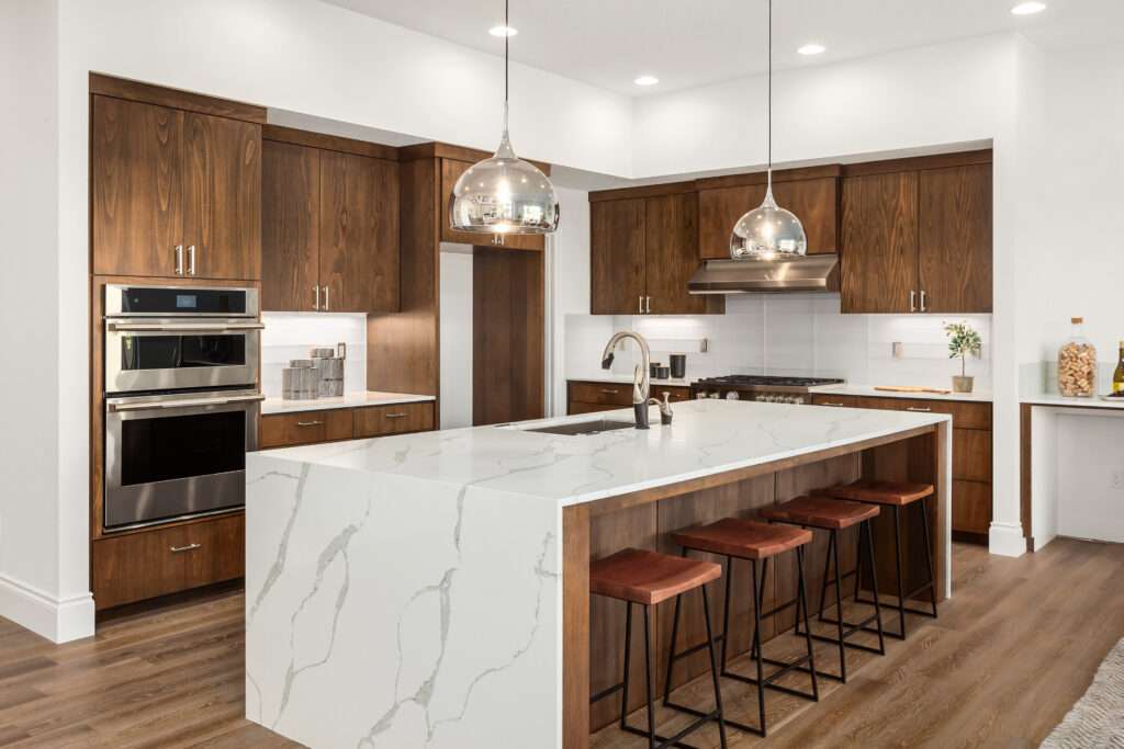 waterfall island, engineered flooring , undermount sink, quartz tops